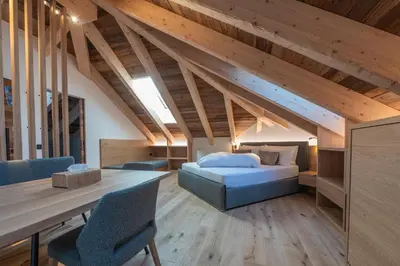 a bedroom with a bed and a table in a room at Il rifugio dei sogni - Exclusive Apartments in San Sigismondo