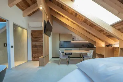 a bedroom with a bed and a table in a room at Il rifugio dei sogni - Exclusive Apartments in San Sigismondo