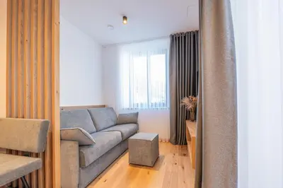 a view of the ocean from a window with curtains at Plan de Corones Apartment in San Sigismondo