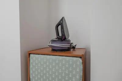 a bedroom with a bed and a desk with a tv at Plan de Corones Apartment in San Sigismondo