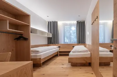 a bedroom with a large white bed with shelves at Plan de Corones Apartment in San Sigismondo