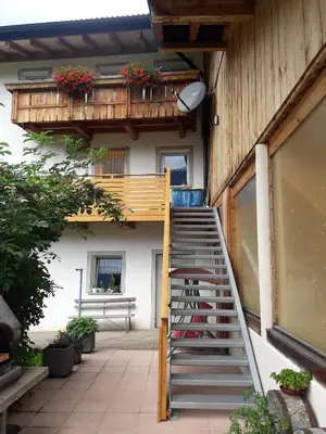 a staircase leading up to a building with a balcony at Hofstatthof in Campo di Trens