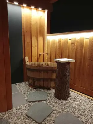 a wooden bathroom with a wooden tub and a sink at Hofstatthof in Campo di Trens