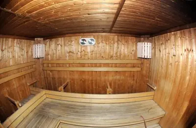 an inside of a wooden sauna with aperature at Bilocale Casa Canazei in Alba di Canazei