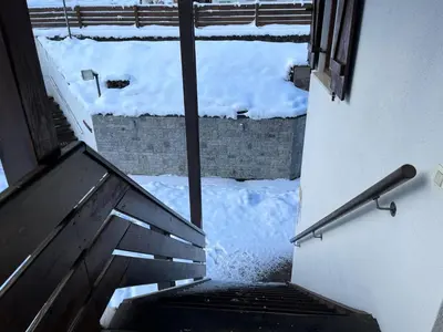 a view of a stairway with snow on the ground at Bilocale Casa Canazei in Alba di Canazei