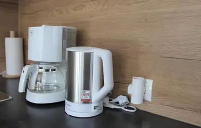 a white coffee maker sitting on a counter at Fox Appartements in San Lorenzo di Sebato