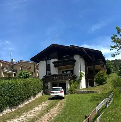a white car parked in front of a house at Villa Claudio in Cavareno