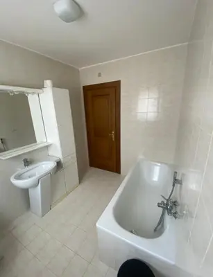 a bathroom with a toilet and a tub and a sink at Villa Claudio in Cavareno
