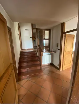 an empty hallway with stairs in a house at Villa Claudio in Cavareno
