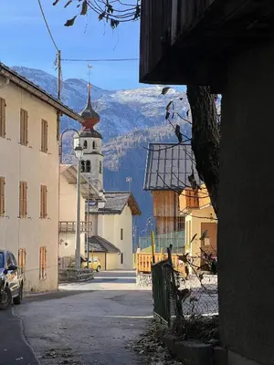 a view of a town with a church and a mountain at Vicinanza d'Andraz in Andraz