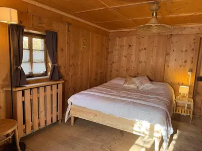 a bedroom with a bed in a wooden room at Vicinanza d'Andraz in Andraz