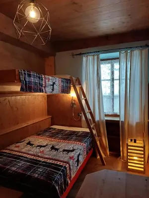 a bedroom with a bunk bed and a window at Sweet Home Cortina in Cortina dʼAmpezzo