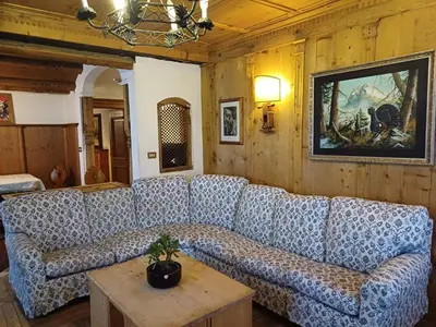 a living room with a couch and a table at Sweet Home Cortina in Cortina dʼAmpezzo