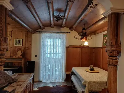 a dining room with a table and a window at Sweet Home Cortina in Cortina dʼAmpezzo