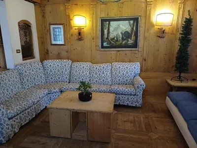 a living room with a couch and a table at Sweet Home Cortina in Cortina dʼAmpezzo