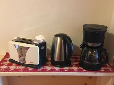 a coffee maker and a toaster on a shelf at Ciasa Rü in San Cassiano