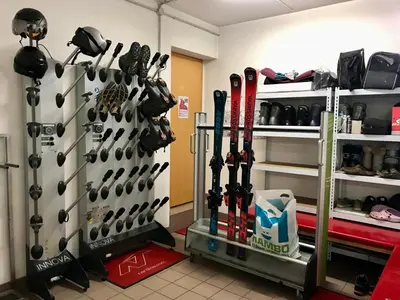 a room with skis hanging on a wall at Appartamenti Majon Sotroi in Campitello di Fassa