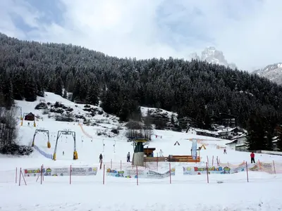 a group of people on a ski slope in the snow at Appartamenti Majon Sotroi in Campitello di Fassa