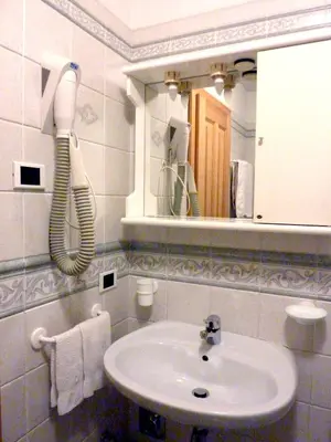 a bathroom with a sink and a mirror at Appartamenti Majon Sotroi in Campitello di Fassa
