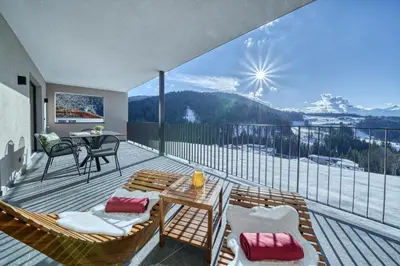 a balcony with chairs and a table with a view at Hinterrainerhof - Nature Apartments in Avelengo
