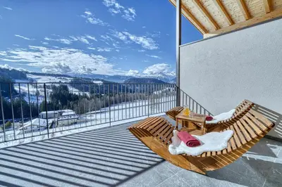 a balcony with a table and chairs and mountains at Hinterrainerhof - Nature Apartments in Avelengo