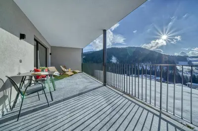 a bedroom with a large bed with a large window at Hinterrainerhof - Nature Apartments in Avelengo