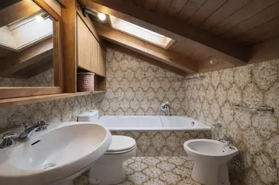 a bathroom with a sink and a toilet and a tub at Alverà Apartment in Cortina dʼAmpezzo