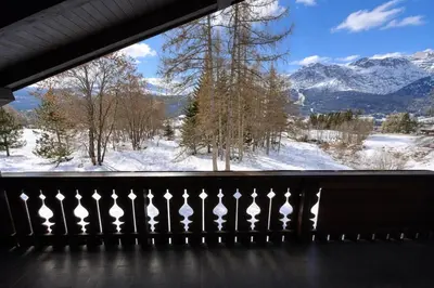 a balcony with a view of snow covered mountains at Alverà Apartment in Cortina dʼAmpezzo