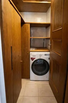 a washer and dryer in a small kitchen at Alverà Apartment in Cortina dʼAmpezzo