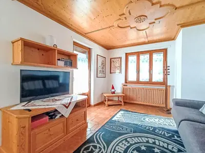 a living room with a tv and a couch at Apartment Casa Dalpi by Interhome in Predazzo