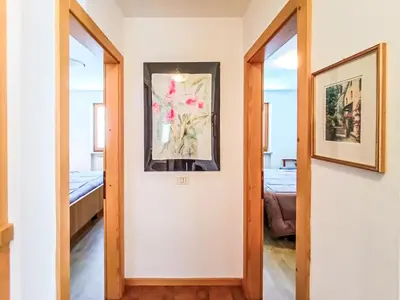 a hallway with a mirror and a picture on the wall at Apartment Casa Dalpi by Interhome in Predazzo