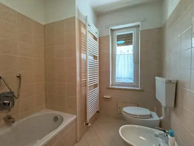 a bathroom with a tub and a toilet and a sink at Apartment Casa Dalpi by Interhome in Predazzo