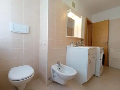a bathroom with a toilet and a sink at Apartment Casa Dalpi by Interhome in Predazzo