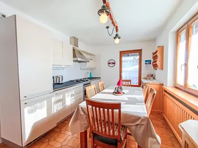 a kitchen with a table and chairs in a room at Apartment Casa Dalpi by Interhome in Predazzo