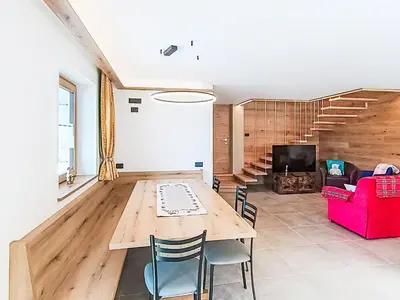 a kitchen with a table and chairs and windows at Apartment Valeria by Interhome in Pera