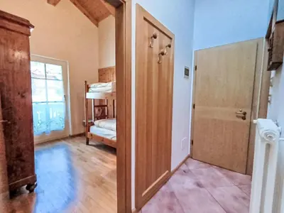 an open door to a room with a bedroom at Apartment Cesa sot Larsec by Interhome in Campestrin