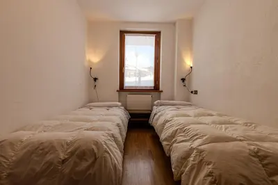 a row of beds in a room with a window at Casa Irene in Mareson