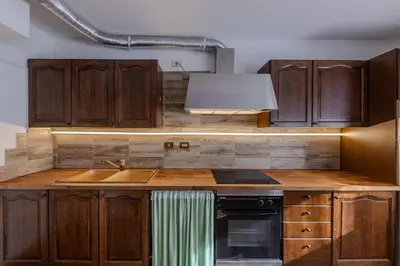 a kitchen with wooden cabinets and a sink at Casa Irene in Mareson
