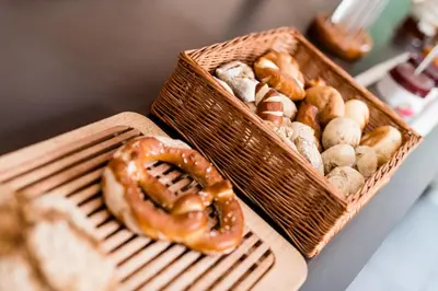 two baskets of different types of donuts on a table at Hotel Jardis in Lana