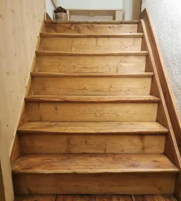 a set of wooden stairs in a house at Balcone sul Civetta in Colle Santa Lucia