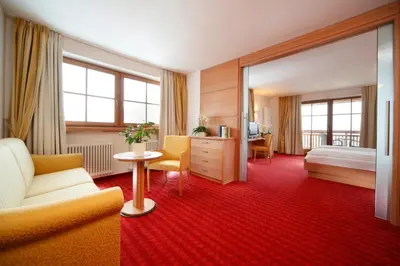 a hotel room with a bed and a couch at Hotel Peter in Petersberg