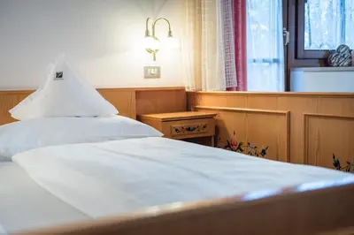 a hotel room with a bedroom and a bed at Hotel Peter in Petersberg
