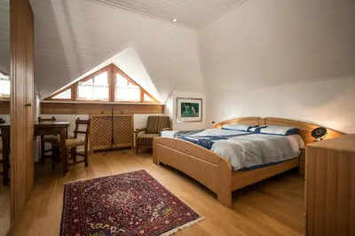 a bedroom with a bed and a table and a window at Villa Sissi in Laives