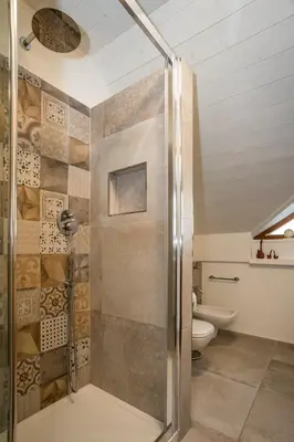 a bathroom with a shower and a toilet at Villa Sissi in Laives