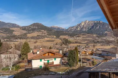 a view of a village with mountains in the background at Duplex Cermis in Cavalese