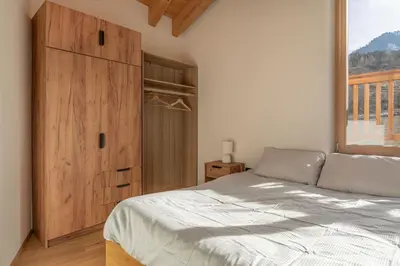 a bedroom with a bed and a large window at Duplex Cermis in Cavalese