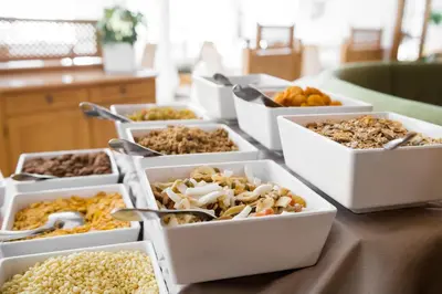 a table topped with trays of different types of food at Hotel Grones in Ortisei