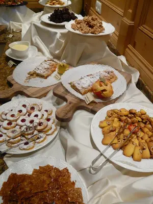 a table with many plates of food on it at Hotel Grones in Ortisei
