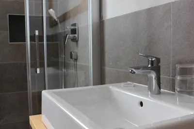 a bathroom with a sink and a shower at Berghaus-Olymp Kronplatz in Brunico