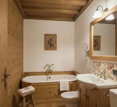 a bathroom with a tub and a toilet and a sink at Dolomiti Magic in Cortina dʼAmpezzo